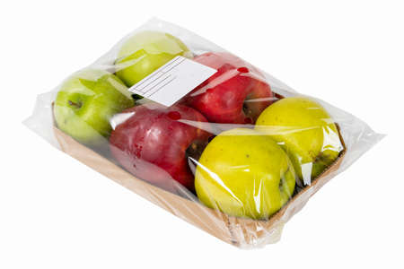 Labeled and packaged yellow, green and red apple on white backgroundの写真素材
