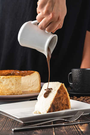 Sliced san sebastian cheesecake with coffee on wooden table
