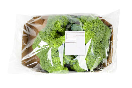 Packaged and labeled broccoli on an isolated white backgroundの写真素材