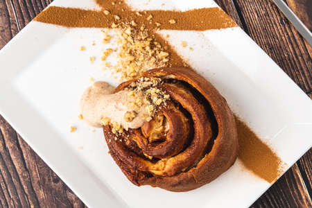 Spiral apple cake or muffin with cup of fresh coffee on wooden backgroundの写真素材