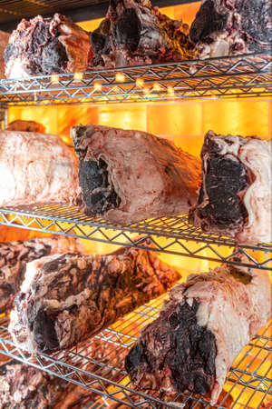 Beef hung and lined up in a dry aged beef cabinetの写真素材