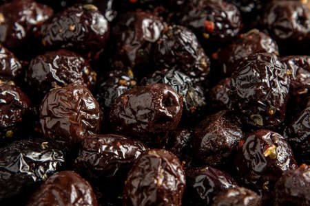 Black olives with paprika and thyme covering the entire screen for background useの写真素材