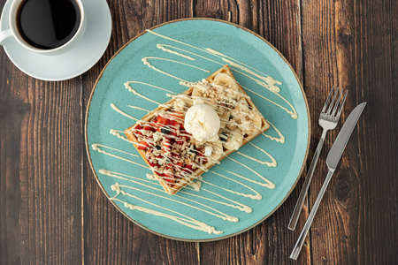 belgium waffles with strawberry and banana and a cup of coffeeの写真素材