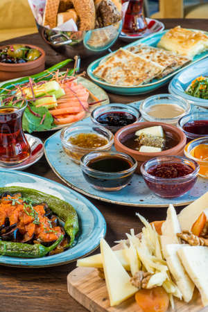 Traditional Turkish Breakfast served with traditional turkish tea on stone table