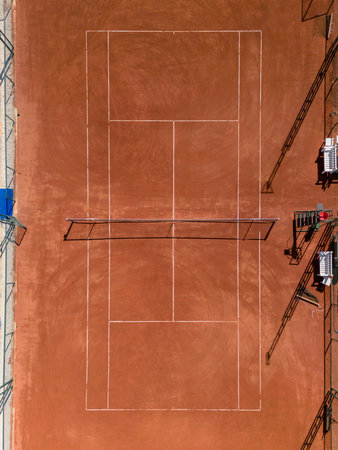 Aerial view of empty clay tennis court on a sunny dayの写真素材
