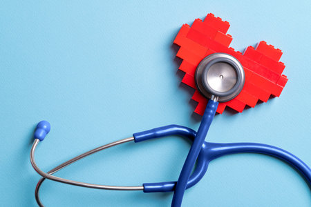 Blue stethoscope standing on red heart on blue backgroundの写真素材