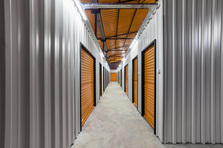 Corridor of self storage unit with red doors. Rental Storage Unitsの写真素材