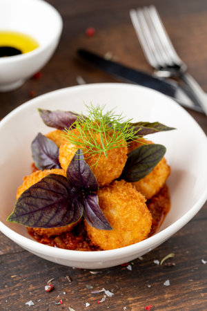 Homemade Fried Sicilian Arancini stuffed with meat, with tomato sauceの写真素材
