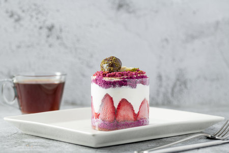 Strawberry shortcake with tea on a white porcelain plateの写真素材