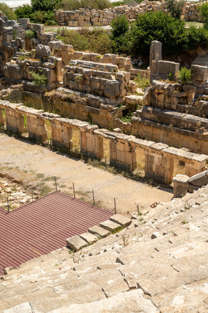 The ruins of the amphitheater and ancient rock tombs in the ancient city of Myra in Demre, Turkeyの写真素材