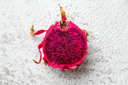 Ripe red dragon fruit on stone tableの写真素材