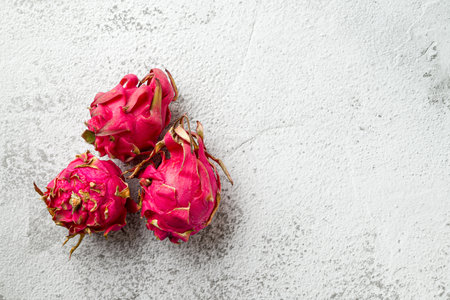 Ripe red dragon fruit on stone tableの写真素材