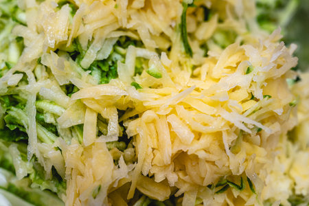 Shredded raw zucchini and potatoes fill the picture. Background of zucchini mucverの写真素材