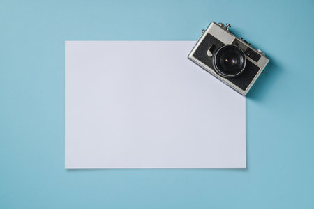 Vintage photo camera and empty photo frames on blue background. Travel moment conceptの写真素材
