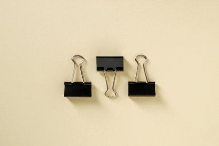 Black binder paper clip on yellow backgroundの写真素材