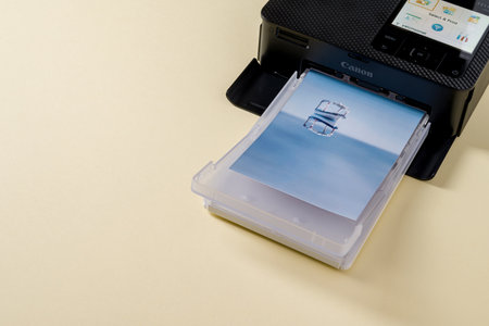 Antalya, Turkey - January 31, 2024: Canon Selphy CP1500 mobile photo printer on yellow backgroundのeditorial素材