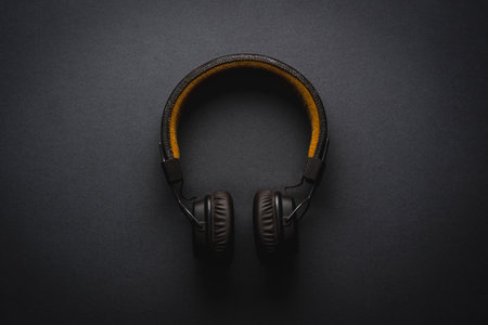 Retro style wireless over-ear headphones on dark gray backgroundの写真素材