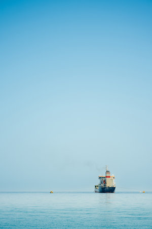 Oil chemical tanker anchored in the Mediterranean sea on a cloudy day