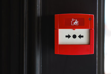 Full front view of outdoor wall mounted fire alarm buttonの写真素材