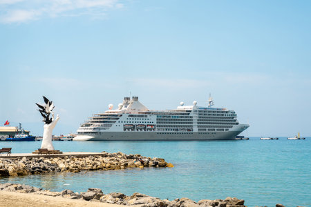 Aydin Kusadasi, Turkey - 4 July 2024: Hand of Peace Sculpture and cruise ship behind it in Kusadasi Aydinのeditorial素材