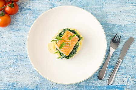 Grilled salmon fillet with vegetables mix on a white porcelain plateの写真素材