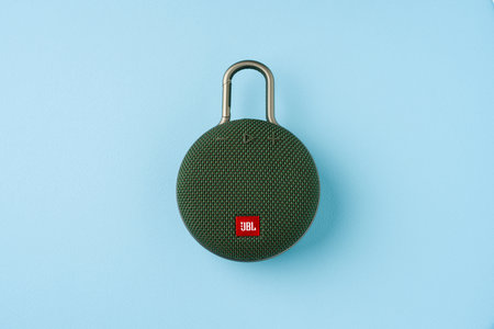 Antalya, Turkey - October 16, 2024: Green portable speaker JBL Clip 3 on a blue backgroundのeditorial素材