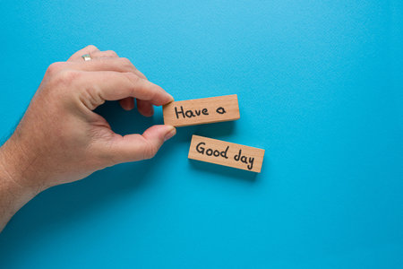 Have a good day is written on wooden blocks standing on a blue backgroundの写真素材