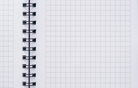 Top view of blank notebook page with black spiral and squaresの写真素材