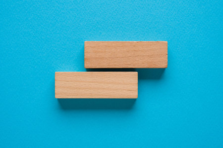 Blank wooden blocks on a blue background that can be written onの写真素材
