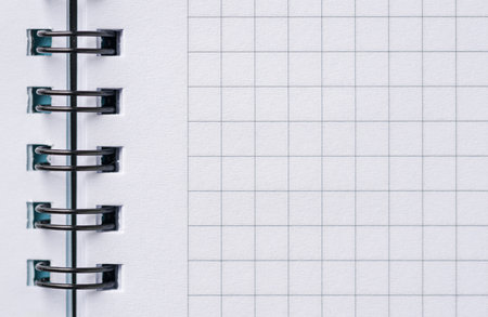 Top view of blank notebook page with black spiral and squaresの写真素材