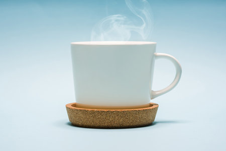 White porcelain tea or coffee cup on blue backgroundの写真素材