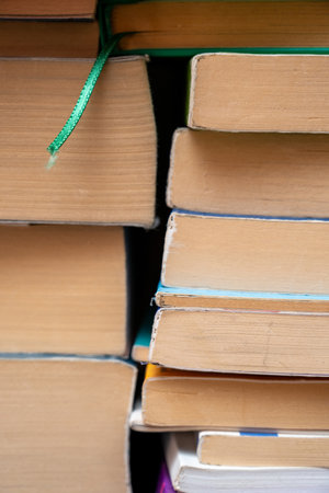 Front close-up view of stacked books and their pages