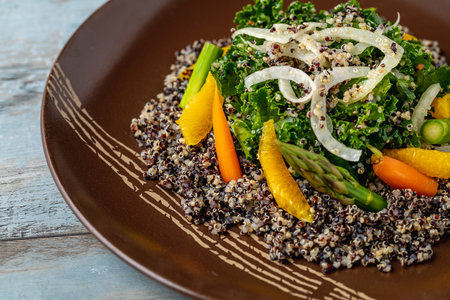 Top view of quinoa salad with orange, kale leaves and asparagusの写真素材