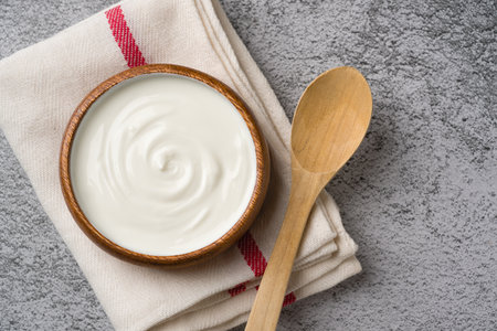 Top view of yogurt in bowl on gray stone table. Healthy eating conceptの写真素材