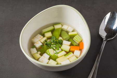 Italian minestrone soup with diced vegetables in a clear brothの写真素材