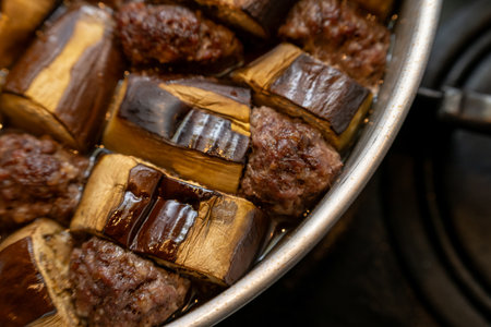 Homestyle eggplant and meatball stew cooked in a metal potの写真素材