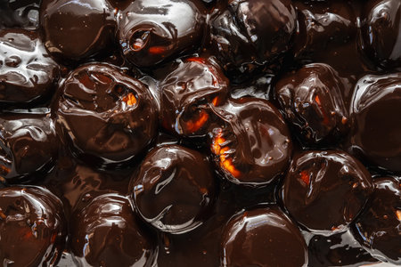 Classic profiteroles coated in rich, glossy dark chocolate sauceの写真素材