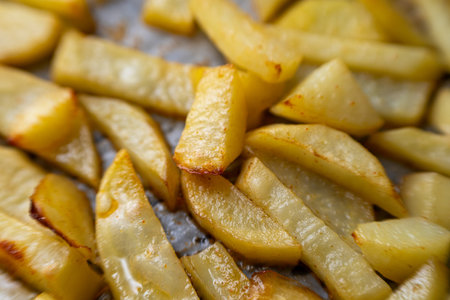 Homemade golden potato wedges baked in the oven, close-upの写真素材