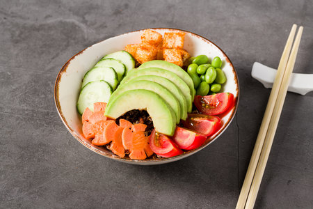 Colorful vegan poke bowl with avocado, edamame, and rice