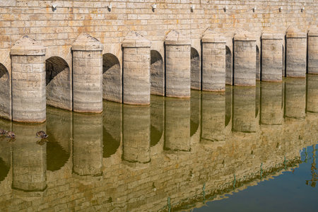 The historic stone bridge in BeyÅehir, Konya, is reflected in the calm water. Turkish name Taskopru or Tas Kopruの写真素材