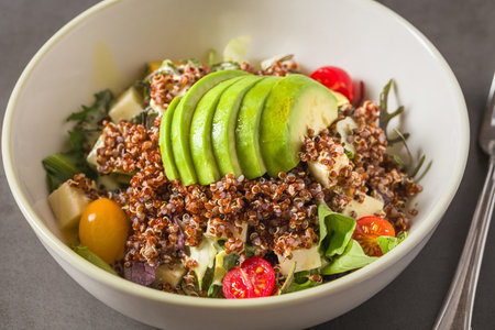 Fresh quinoa salad with avocado, cherry tomato and mixed greens