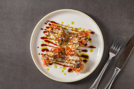 Crispy bruschetta with tomato, cheese, basil and balsamic drizzle