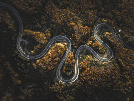 Aerial view of cars driving on the forest road between Domanic and Inegol in autumn, taken with a droneの写真素材
