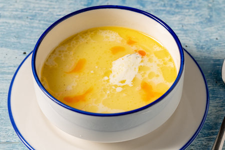 Creamy seafood soup with shrimp and spices served in white bowlの写真素材