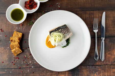 Elegant fine dining sea bass fish dish with modern Italian restaurant presentation