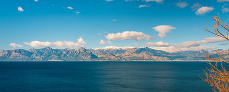 Mediterranean Sea with snowy Taurus Mountains under clear blue skyの写真素材