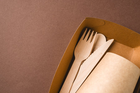 Eco takeaway packaging with wooden cutlery and paper cups