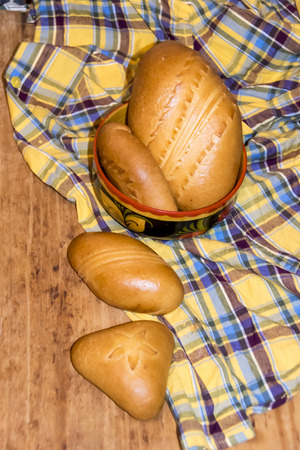 Russian traditional pie pierog pirog On a tablecloth bowl Khokhloma wooden tableの写真素材
