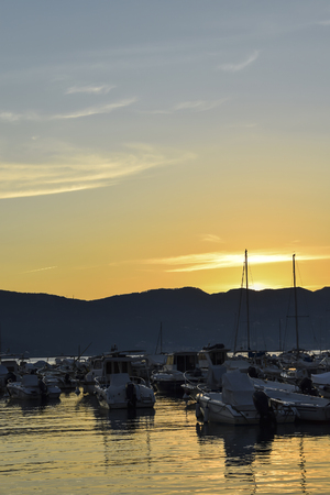Many boats on the dock beautiful sunset on the seaの写真素材