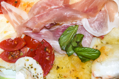 Antipasti prosciutto basil mozzarella tomatoes cheeseの写真素材